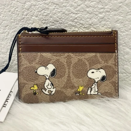 NWT COACH x Peanuts Mini Skinny ID Case CBT14 in Signature Canvas with Snoopy Print NWT COACH x Peanuts Mini Skinny ID Case CBT14 in Signature Canvas with Snoopy Print