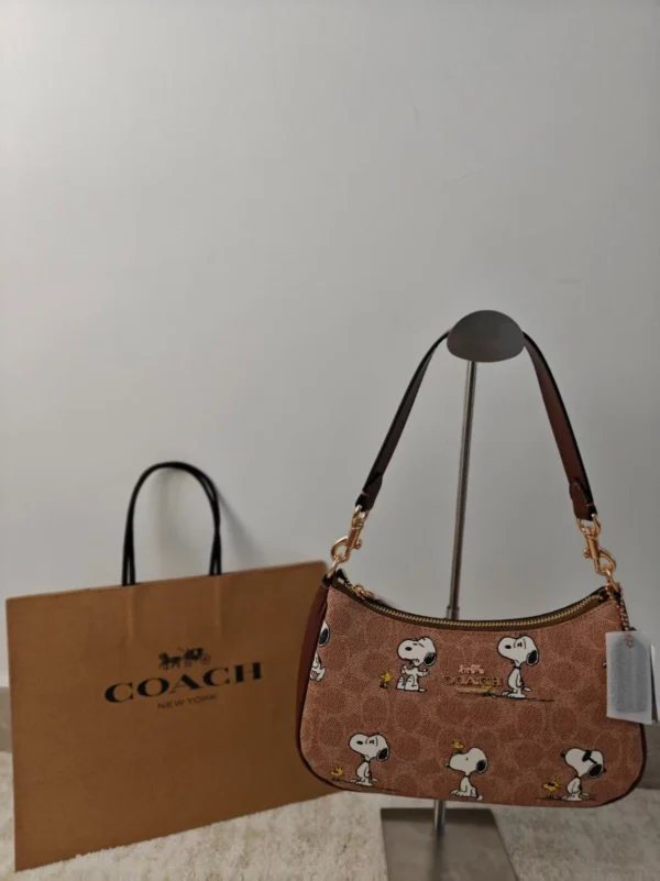 COACH x Peanuts Teri Shoulder Bag CBJ88 in Tan Brown Signature Canvas with Snoopy Print COACH x Peanuts Teri Shoulder Bag CBJ88 in Tan Brown Signature Canvas with Snoopy Print