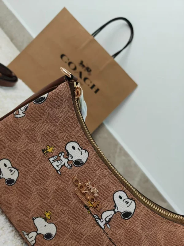 COACH x Peanuts Teri Shoulder Bag CBJ88 in Tan Brown Signature Canvas with Snoopy Print COACH x Peanuts Teri Shoulder Bag CBJ88 in Tan Brown Signature Canvas with Snoopy Print