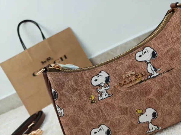 COACH x Peanuts Teri Shoulder Bag CBJ88 in Tan Brown Signature Canvas with Snoopy Print COACH x Peanuts Teri Shoulder Bag CBJ88 in Tan Brown Signature Canvas with Snoopy Print