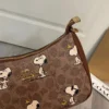 COACH x Peanuts Teri Shoulder Bag CBJ88 in Tan Brown Signature Canvas with Snoopy Print COACH x Peanuts Teri Shoulder Bag CBJ88 in Tan Brown Signature Canvas with Snoopy Print