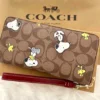 COACH x Peanuts CE705 Long Zip Around Wallet in Khaki Signature Canvas with Snoopy and Woodstock
