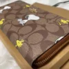 COACH x Peanuts CE705 Long Zip Around Wallet in Khaki Signature Canvas with Snoopy and Woodstock